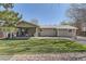 Spacious backyard with a covered patio and lush green lawn at 6953 W Roxbury Pl, Littleton, CO 80128