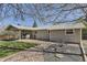 Wide angle of backyard with lush lawn and covered patio with dining set at 6953 W Roxbury Pl, Littleton, CO 80128
