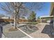 Landscaped backyard featuring a patio, a fire pit and mature trees at 6953 W Roxbury Pl, Littleton, CO 80128
