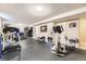 Finished basement with gym equipment and rubber flooring offers a versatile space for exercise and recreation at 6953 W Roxbury Pl, Littleton, CO 80128
