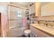Bright bathroom with a tiled tub, a shower, and a light pink vanity at 6953 W Roxbury Pl, Littleton, CO 80128