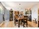 Light-filled dining room boasts a beautiful wood table, hardwood floors, and a charming display case with glass blocks at 6953 W Roxbury Pl, Littleton, CO 80128