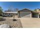Charming single-story home featuring a well-manicured yard and attached two-car garage at 6953 W Roxbury Pl, Littleton, CO 80128