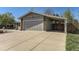 Two-car garage and connected carport, offering parking and exterior storage space at 6953 W Roxbury Pl, Littleton, CO 80128