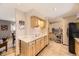 Kitchen featuring light wood cabinets, granite countertops, and convenient access to dining area at 6953 W Roxbury Pl, Littleton, CO 80128