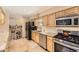 Well-equipped kitchen with stainless steel appliances, granite countertops, and tile backsplash at 6953 W Roxbury Pl, Littleton, CO 80128