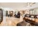 Open-concept living area showcasing hardwood floors, kitchen access, and natural light at 6953 W Roxbury Pl, Littleton, CO 80128