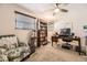 Comfortable home office with neutral walls, a ceiling fan, and a built-in bookcase at 6953 W Roxbury Pl, Littleton, CO 80128