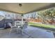 Covered patio with a dining set and a view of the fenced backyard at 6953 W Roxbury Pl, Littleton, CO 80128