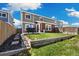 A well-maintained backyard featuring a grassy lawn, a patio, and a wooden fence, perfect for outdoor enjoyment at 5786 Raleigh Cir, Castle Rock, CO 80104