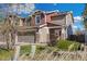Inviting two-story townhome with stone accents, a two-car garage, and established landscaping at 5786 Raleigh Cir, Castle Rock, CO 80104