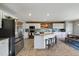 Well-appointed kitchen featuring stainless steel appliances, an island with seating, and a wood backsplash at 5786 Raleigh Cir, Castle Rock, CO 80104