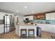 Bright kitchen with stainless steel appliances, an island with seating, and ample counter space at 5786 Raleigh Cir, Castle Rock, CO 80104