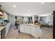 Open concept kitchen with center island flowing into dining and living areas, great for entertaining at 5786 Raleigh Cir, Castle Rock, CO 80104
