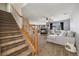 Bright and airy living room with a cozy fireplace, plush seating, and staircase access at 5786 Raleigh Cir, Castle Rock, CO 80104