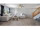 Spacious living room with plush seating, a ceiling fan, and access to the staircase at 5786 Raleigh Cir, Castle Rock, CO 80104