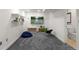 Finished basement with a mounted TV, storage units, and plush carpeting at 9745 Quay Loop, Westminster, CO 80021