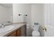Clean bathroom with white walls, toilet and sink at 9745 Quay Loop, Westminster, CO 80021