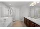 A bright bathroom features a separate shower and tub, double sinks, and tile flooring at 9745 Quay Loop, Westminster, CO 80021
