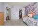 Charming bedroom with a colorful floral accent wall and whimsical decor at 9745 Quay Loop, Westminster, CO 80021