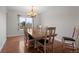 Bright dining room features hardwood floors, natural light, and table set for six at 9745 Quay Loop, Westminster, CO 80021