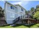 Rear exterior of home featuring a deck, stairs to backyard, and lush green grass at 9745 Quay Loop, Westminster, CO 80021