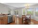 Kitchen with stainless steel appliances, eat-in table and access to outdoor deck at 9745 Quay Loop, Westminster, CO 80021