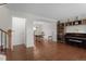 Open-concept living space features hardwood floors, piano, built-in shelving and dining area at 9745 Quay Loop, Westminster, CO 80021