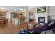 Open concept living room features hardwood floors, fireplace and views of the kitchen at 9745 Quay Loop, Westminster, CO 80021