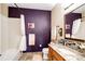 Bathroom with granite vanity, tiled shower, and purple walls at 23376 E 5Th Pl # 101, Aurora, CO 80018