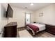 Spacious bedroom with dark wood furniture and a large window at 23376 E 5Th Pl # 101, Aurora, CO 80018