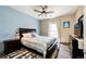 Bedroom with ceiling fan, window, and wood dresser at 23376 E 5Th Pl # 101, Aurora, CO 80018