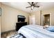 Bedroom with ceiling fan, dresser, and access to bathroom at 23376 E 5Th Pl # 101, Aurora, CO 80018