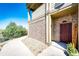 Townhome entrance with brick exterior and a burgundy door at 23376 E 5Th Pl # 101, Aurora, CO 80018