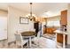 Kitchen with granite countertops, wood cabinets, and a dining area at 23376 E 5Th Pl # 101, Aurora, CO 80018