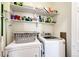 Laundry room with washer, dryer, and storage shelving at 23376 E 5Th Pl # 101, Aurora, CO 80018