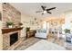 Living room with fireplace, hardwood floors, and open concept to dining area at 23376 E 5Th Pl # 101, Aurora, CO 80018