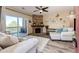 Spacious living room with stone fireplace and access to a balcony at 23376 E 5Th Pl # 101, Aurora, CO 80018
