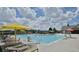 Community pool with lounge chairs and umbrellas at 23376 E 5Th Pl # 101, Aurora, CO 80018