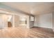 Finished basement space with wood-look floors and neutral walls, offering a versatile area for recreation and relaxation at 6374 Upham St, Arvada, CO 80003