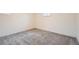 Spacious basement with neutral carpet and walls, and a small window for natural light at 6374 Upham St, Arvada, CO 80003