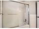 Bathroom showcasing a tiled shower-tub combo with glass sliding doors and tiled walls at 6374 Upham St, Arvada, CO 80003