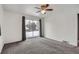 Bright bedroom featuring carpet floors, a ceiling fan, and a sliding glass door to the exterior at 6374 Upham St, Arvada, CO 80003