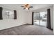 Bedroom with carpet flooring, ceiling fan, and sliding door with backyard views at 6374 Upham St, Arvada, CO 80003