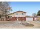 Charming two-story home featuring brick accents and an attached two car garage, offering both curb appeal and practicality at 6374 Upham St, Arvada, CO 80003