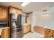 Kitchen area showcases stainless steel refrigerator, cabinets and an open layout adjacent to a dining space at 6374 Upham St, Arvada, CO 80003