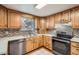 Kitchen featuring stainless steel appliances, wooden cabinetry and a garden view at 6374 Upham St, Arvada, CO 80003