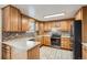 Kitchen with stainless steel appliances, mosaic backsplash, and wood cabinets at 6374 Upham St, Arvada, CO 80003