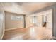 Living room with vinyl floors, neutral walls, and a clear view to the front entry at 6374 Upham St, Arvada, CO 80003