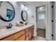 Bathroom with double vanity, modern lighting and large mirrors at 23320 E Berry Ave, Aurora, CO 80016